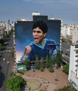 Giant street art mural of Diego Maradona on a building facade in Buenos Aires